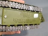 a hand holding a chain that is attached to a tank