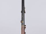 an old bassoon with a wooden body and brass fittings