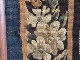 a picture of a close up of a rug with flowers on it