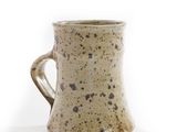 a close up of a coffee mug on a white surface