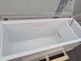 a white bath tub sitting on a pallet in front of a building