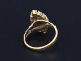 an image of a gold ring with a flower design on it