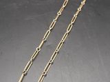 a close up of a gold chain with a clasp on it