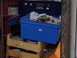 a large metal cage filled with boxes and boxes
