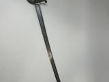 a close up of a sword on a wall with a white background