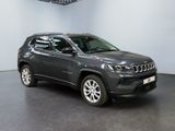 the jeep compass is parked in a large room with a black floor