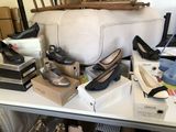 many pairs of shoes on a table in a room