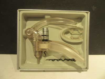 a box with a bottle opener and corkscrews inside of it