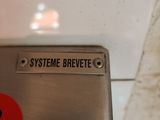 a sign that says systeme brevee on the side of a toilet