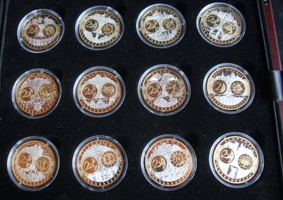 nine different coins in a black box on a table