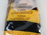 the yellow and black jacket is wrapped in plastic on a white surface