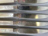 five knives that are sitting on top of each other