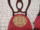 two chairs that are sitting next to each other on the sidewalk