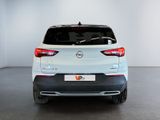 the back of a white nissan qxv parked in a white room