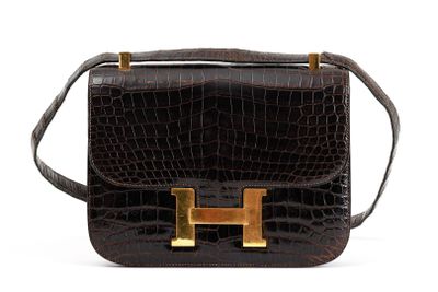 brown leather handbag with gold hardware on the handle