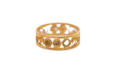 a close up of a gold ring on a white background
