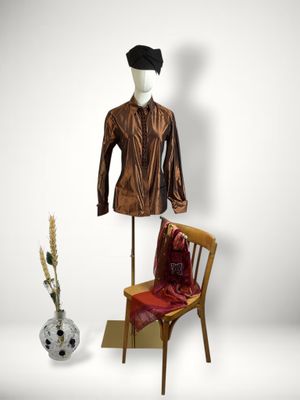 a mannequin and a chair in front of a white wall