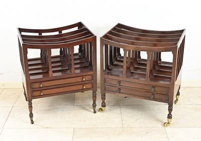 two wooden chairs that are on wheels on the floor