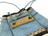a purse made out of old jeans with a tag on it