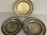 three silver plate dishes on a white table cloth
