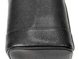 a close up of a black purse on a white surface