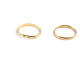 two gold wedding rings on a white background