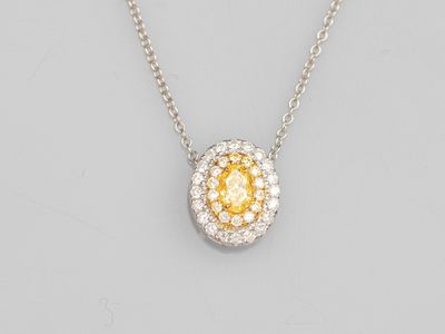 a yellow and white diamond pendant on a chain