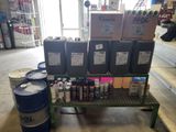 several barrels and cans of paint on a shelf in a store