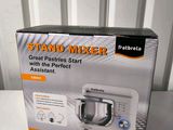 packaging of a stand mixer sitting on a table in front of a white wall