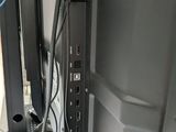 a computer monitor and a cell phone on a desk