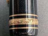 an image of a close up of a fountain pen with a gold band