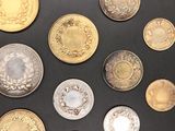 a lot of coins that are on a black surface
