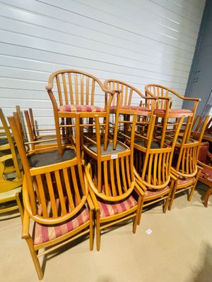 a lot of wooden chairs and tables in a room