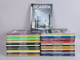 many books stacked on top of each other on a table