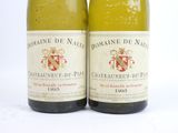two bottles of wine sitting next to each other on a white surface