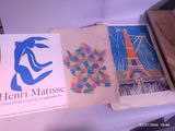 three books that are on a table with pictures on them