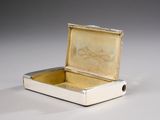 a small silver box that is open on a table