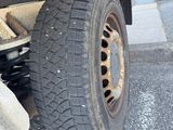 a tire that is sitting on the side of a truck
