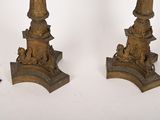 pair of antique brass candlesticks with lions and lions on them