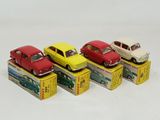 several toy cars are lined up in a row on a white surface