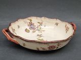 an image of a bowl with flowers on it sitting on a table