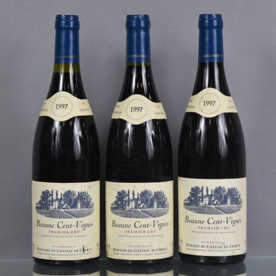 three bottles of wine are lined up on a table