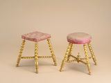 pair of antique brass stools with pink velvet upholstered seat