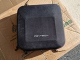 a black case sitting on top of a cardboard box