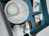 a cup and saucer in a box on a table