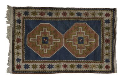 a blue and brown rug with a star design on it