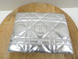 a silver purse sitting on top of a wooden table
