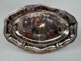 a silver tray with a gold handle on a table