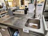 a sink in the middle of a counter in a store