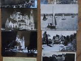 several old black and white photos of people and buildings on a table